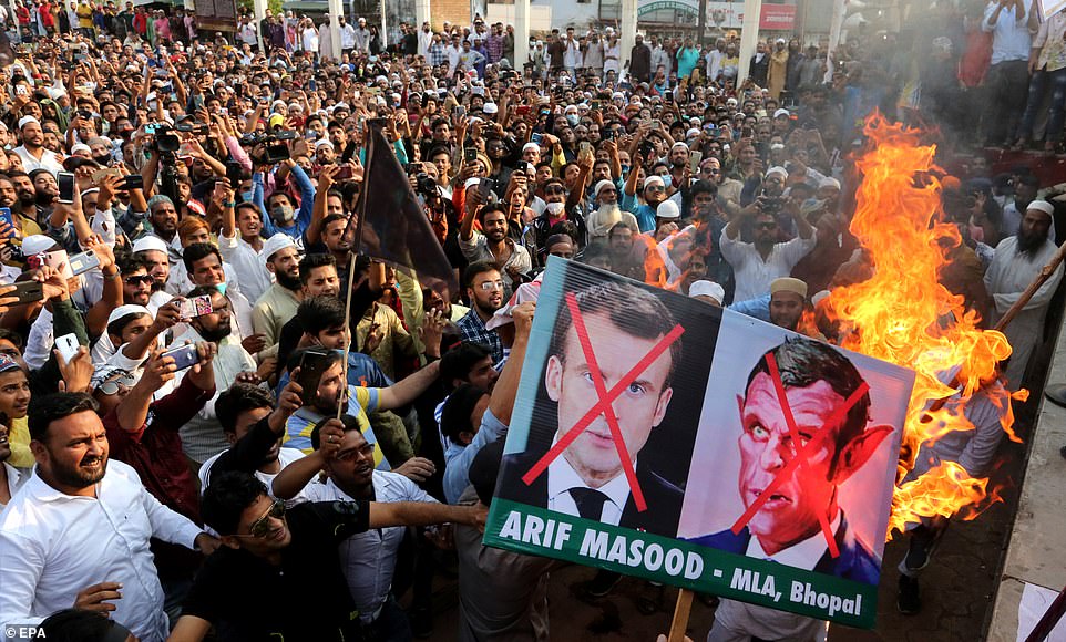 Indian Muslims burn posters of Emmanuel Macron during protest against his defence of cartoons of the Prophet Mohammed
