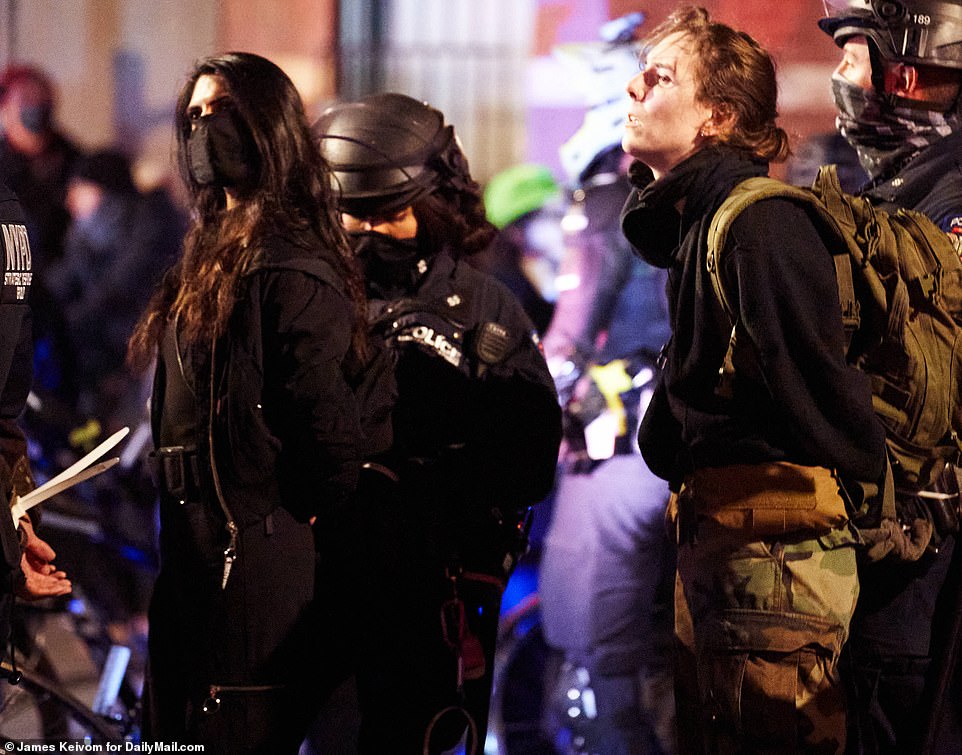 Singh, pictured left, was one of more than 50 people arrested during a night of unrest in New York