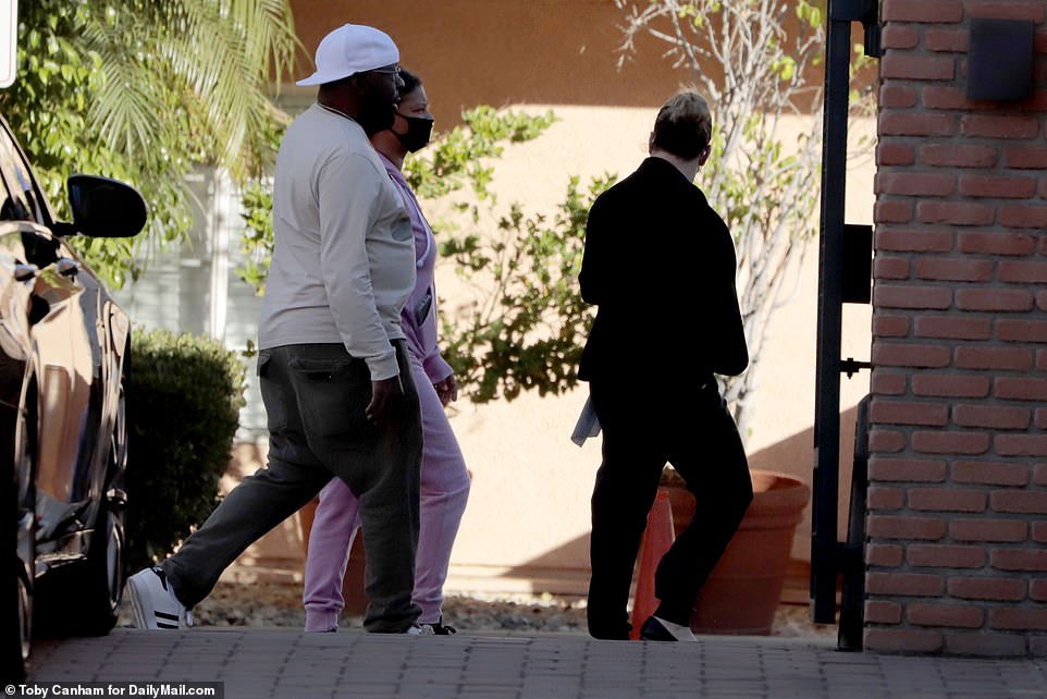 Brown was led to the guard booth at his gated community and appeared to be shown CCTV footage by LAPD detectives who had arrived at the scene earlier