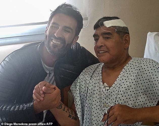 Diego Maradona's death is being treated as possible manslaughter and police have raided the home of his personal doctor Leopoldo Luque (pictured together)