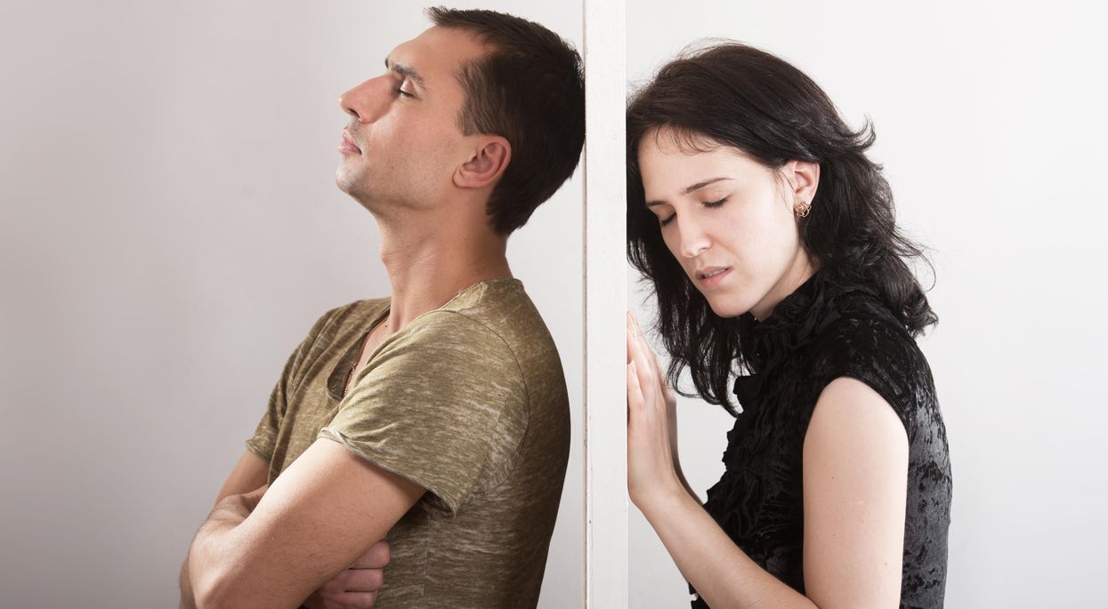 woman and man on either side of door