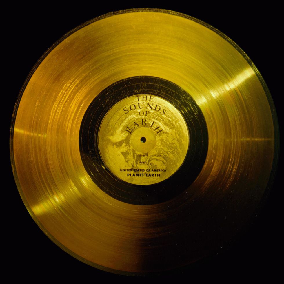 Flying on board Voyagers 1 and 2 are identical \u2018golden\u2019 records, carrying the story of Earth far into deep space. The 12 inch gold-plated copper discs contain greetings in 60 languages, samples of music from different cultures and eras, and natural and man-made sounds from Earth. They also contain electronic information that an advanced technological civilization could convert into diagrams and photographs. The cover of each gold plated aluminum jacket, designed to protect the record from micrometeorite bombardment, also serves a double purpose in providing the finder a key to playing the record. The explanatory diagram appears on both the inner and outer surfaces of the cover, as the outer diagram will be eroded in time. Currently, both Voyager probes are sailing adrift in the black sea of interplanetary space, having left our solar system years ago.