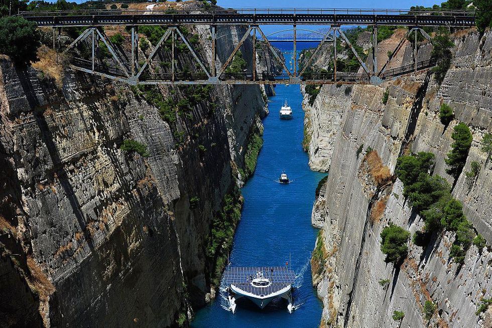 The world's largest solar-powered boat, "MS Turanor PlanetSolar" sails through the Corinth Canal near the town of Corinth on July 28, 2014. The boat arrived to Greece as part of a joint archaeological project focused on underwater exploration off one of Europe's oldest human occupation sites, the Franchthi cave in the Argolid, southeast Peloponnese. The project is taking place in one of Greece's richest archaelogical areas, the Argolid, known for its major palatial complexes in the Bronze Age that include Mycenae and Tiryns and later, classical-era city-states and sites like Argos and the ancient-theatre site of Epidaurus.