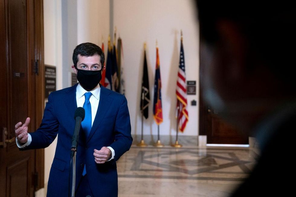 WASHINGTON, DC - JANUARY 21: Pete Buttigieg, U.S. secretary of transportation nominee for U.S. President Joe Biden, wears a protective mask while speaking to members of the media after a Senate Commerce, Science and Transportation Committee confirmation hearing on January 21, 2021 in Washington, D.C. Buttigieg, is pledging to carry out the administration\u2019s ambitious agenda to rebuild the nation\u2019s infrastructure, calling it a \u201cgenerational opportunity\u201d to create new jobs, fight economic inequality and stem climate change.
