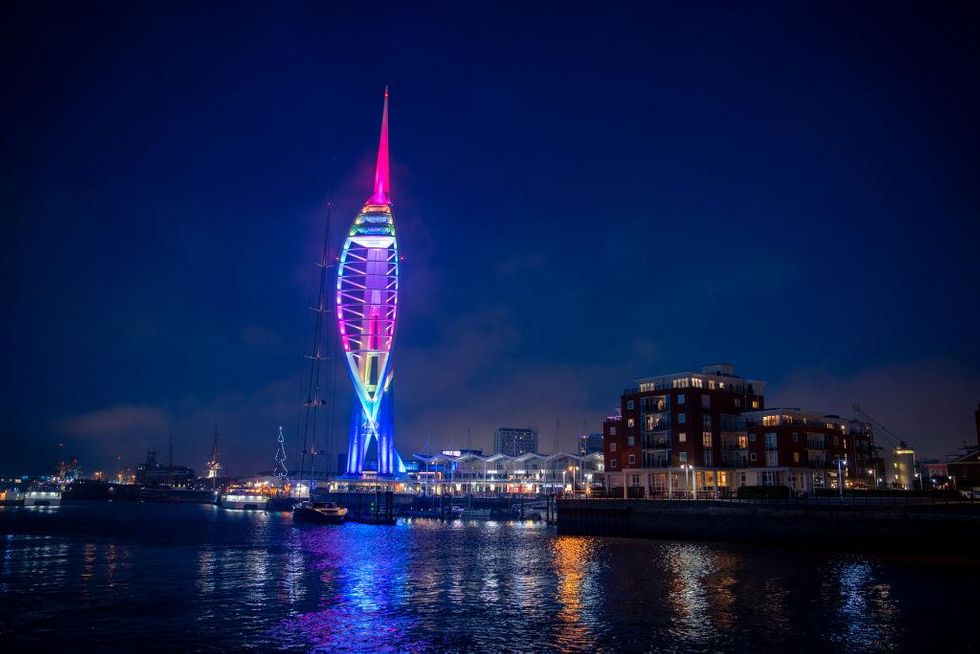 Spinnaker Tower is lit up on New Years Eve on December 31, 2020 in Portsmouth, England. From Thursday, three-quarters of the population of England -- 44.1 million people -- will be in the top tier of lockdown measures as the new strain of the virus piles pressure on hospitals already stretched to capacity by the pandemic.