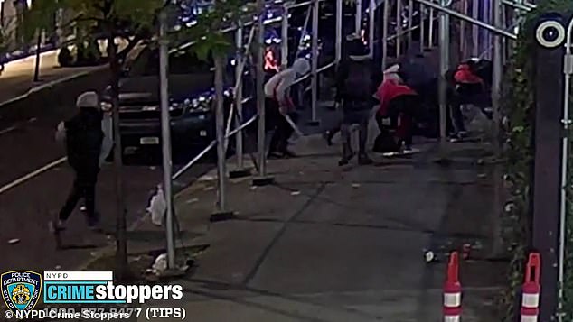 A group of six additional unidentified males then run towards the man as he struggles to get up and begin 'stabbing and slashing' him