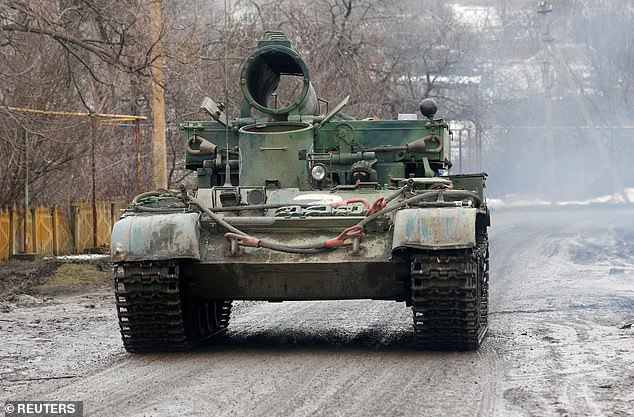 Pictured: A tank driven by pro-Russian forces is seen moving through the Donetsk region
