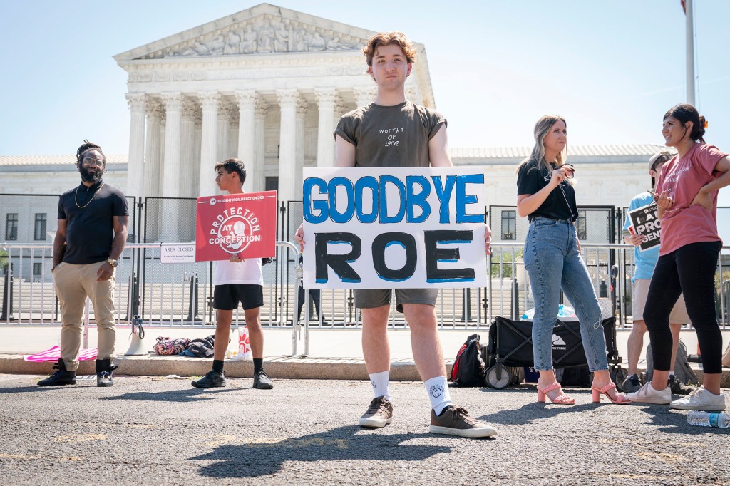 Noah Slayter, 20, of Manassas, Va., poses while protesting outside the Supreme Court on June 15.