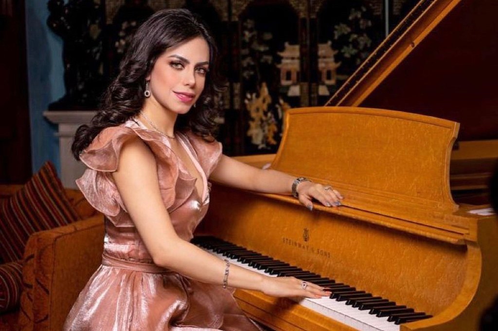 Yrma Lydya sitting at a piano.