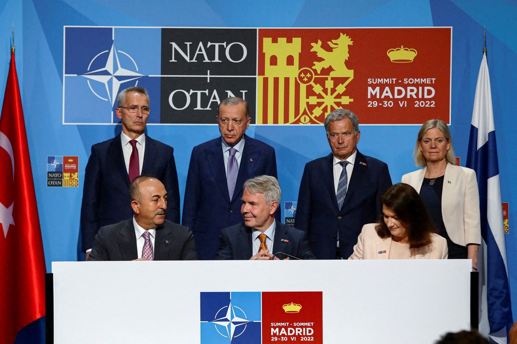 Turkish President Tayyip Erdogan, Finland's President Sauli Niinisto, Sweden's Prime Minister Magdalena Andersson, NATO Secretary General Jens Stoltenberg, Turkish Foreign Minister Mevlut Cavusoglu, Sweden's Foreign Minister Ann Linde and Finnish Foreign Minister Pekka Haavisto react during a NATO summit in Madrid, Spain, June 28, 2022.