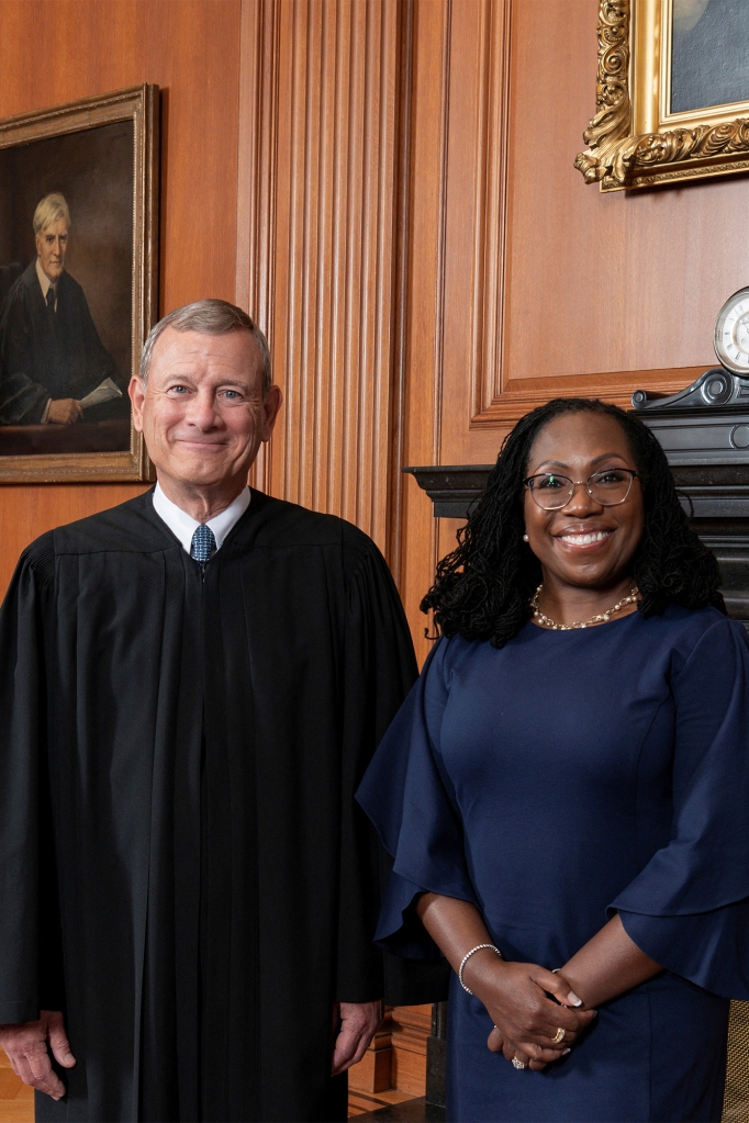 Judge Ketanji Brown Jackson poses with Supreme Court Chief Justice John Roberts.