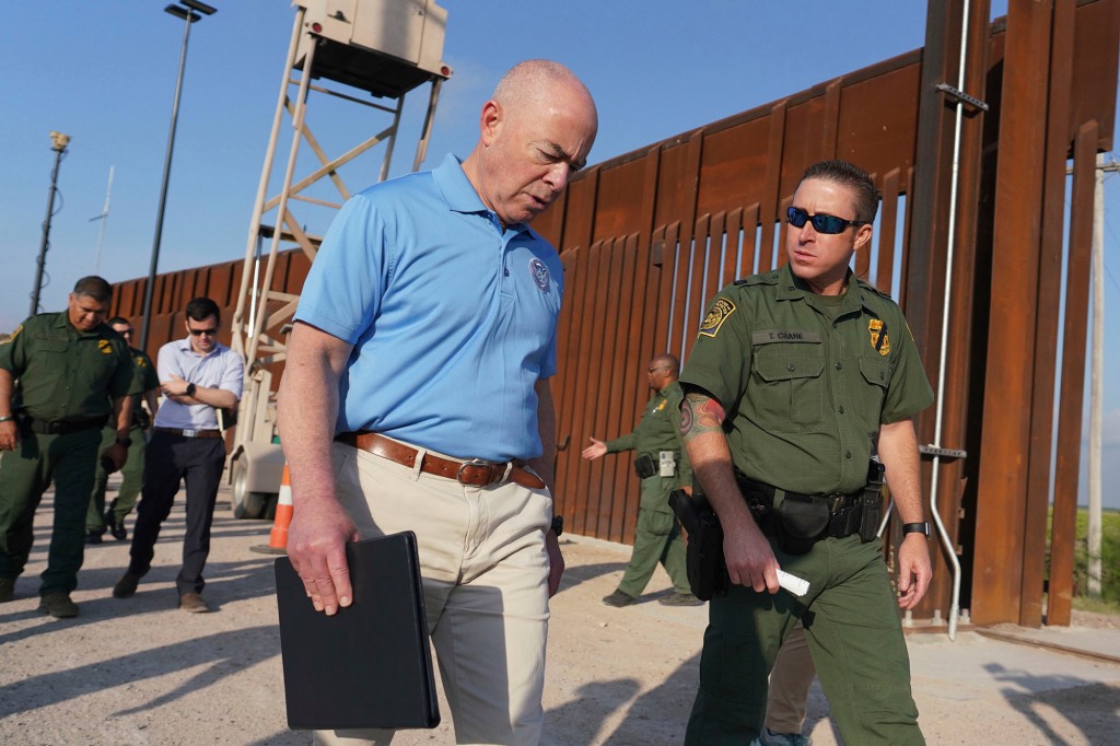Homeland Security Secretary Alejandro Mayorkas (left) listens to Deputy patrol agent in charge of the US Border Patrol Anthony Crane.