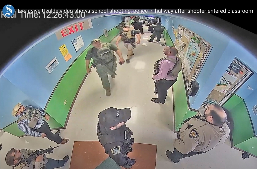 Authorities stage in a hallway as they respond to the shooting at Robb Elementary School in Uvalde, Texas, Tuesday, May 24, 2022. 