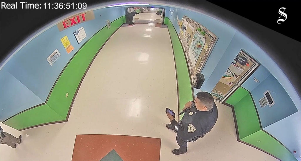 The video shows a police officer checking his phone that allegedly had the "Punisher" logo as his wallpaper. 