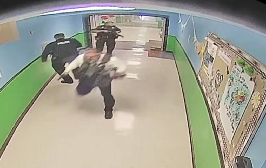 Police run away from the shooting.