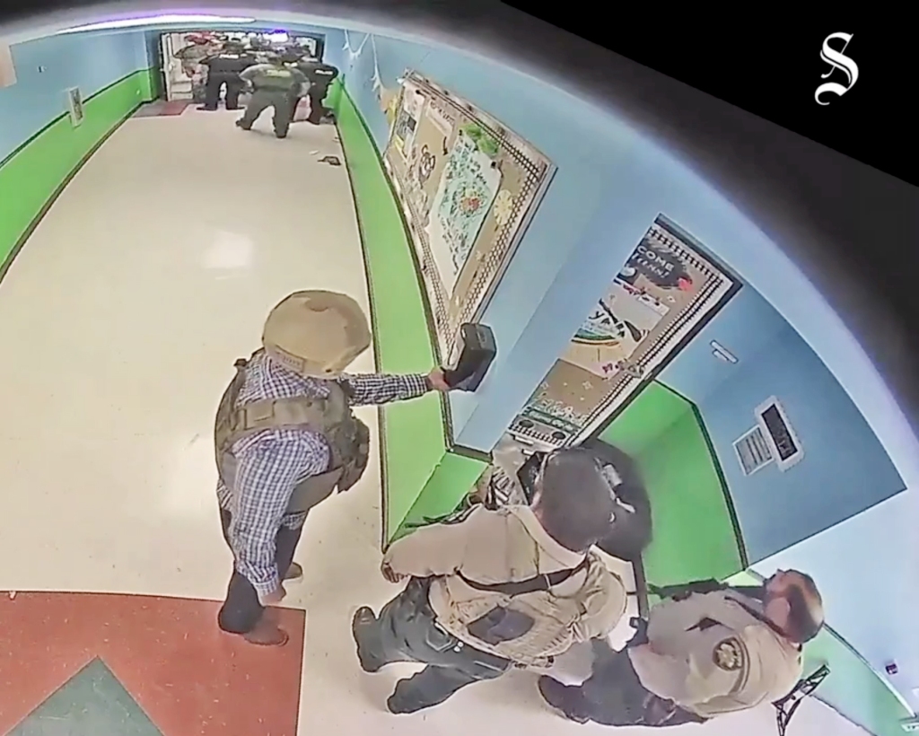 Footage shows a cop reach for hand sanitizer during the chaos.