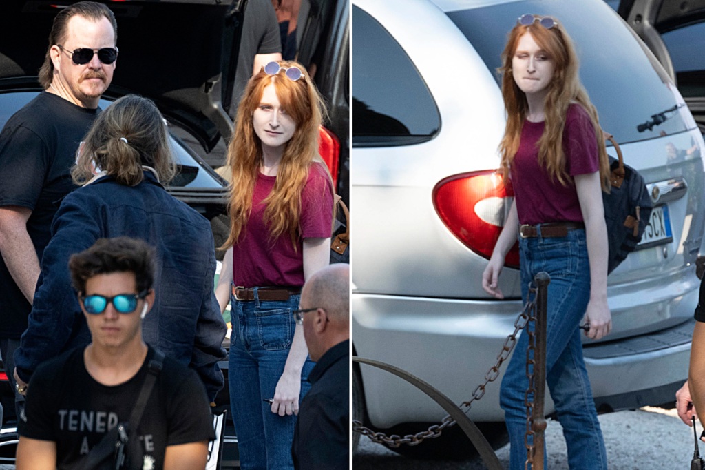 Depp stands next to the redheaded woman.