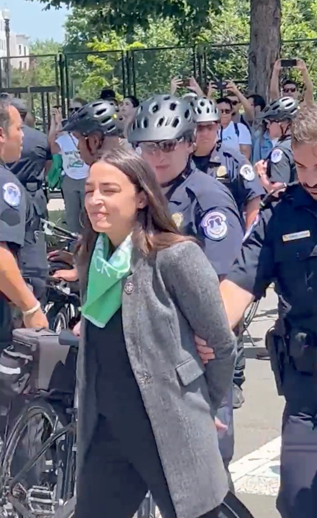 Rep. Alexandria Ocasio-Courtez is escorted away from a pro-abortion protest on July 19, 2022.