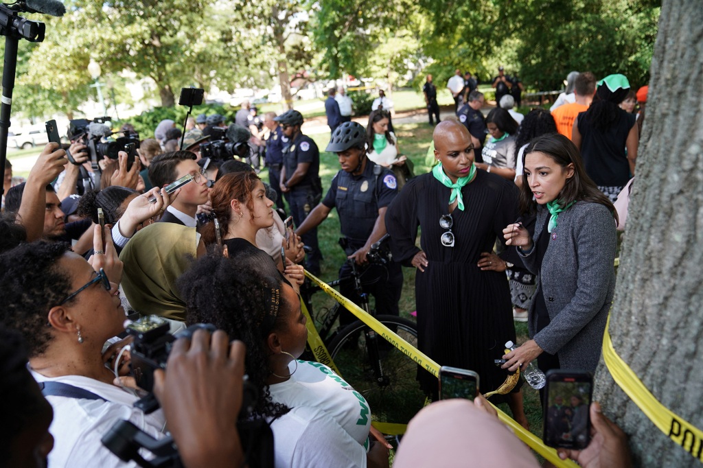AOC talking to the press along with Rep. Ayanna Pressley while being detained.