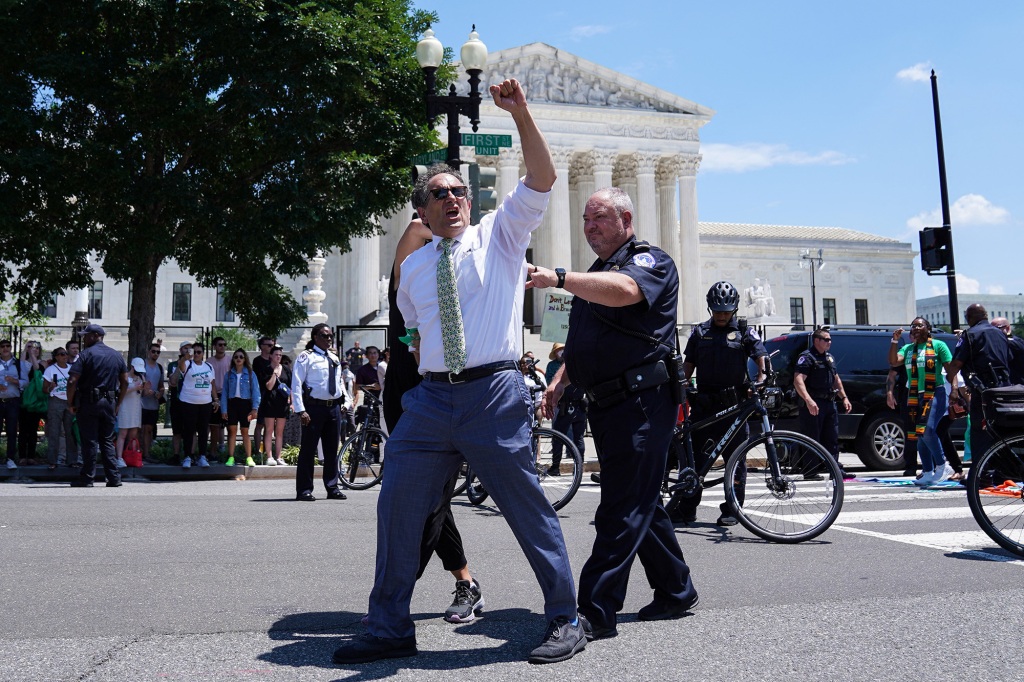 Representatives Andy Levin (D-MI) and Rashida Tlaib (D-MI) are detained during an abortion rights protest outside of the U.S. Supreme Court in Washington, D.C., U.S., July 19, 2022.