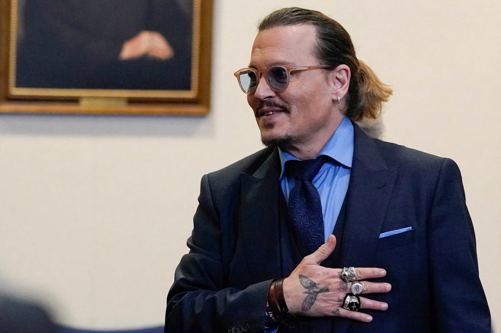 Johnny Depp gestures to spectators in court after closing arguments during his defamation case at the Fairfax County Circuit Courthouse.