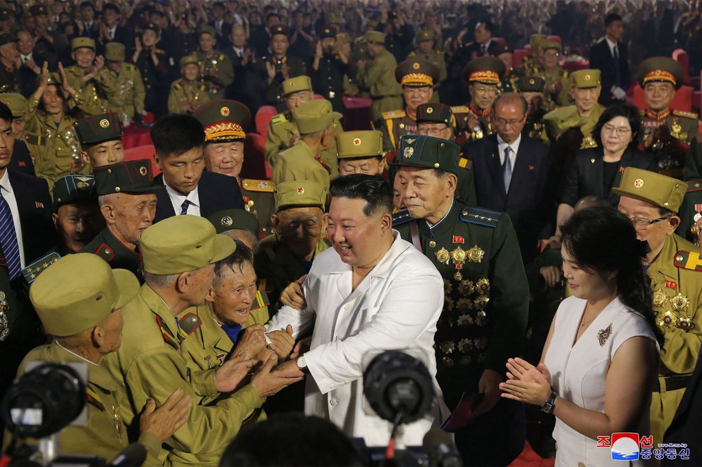 This picture taken on July 27, 2022 and released by North Korea's official Korean Central News Agency (KCNA) on July 28 shows North Korean leader Kim Jong Un (C) shaking hands with old soldiers participating in the 69th anniversary event of the victory in the Korean War in Pyongyang.