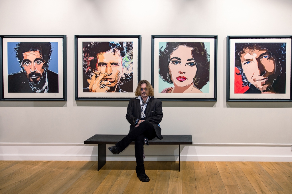 Johnny Depp, the artist, sitting in front of his artwork.