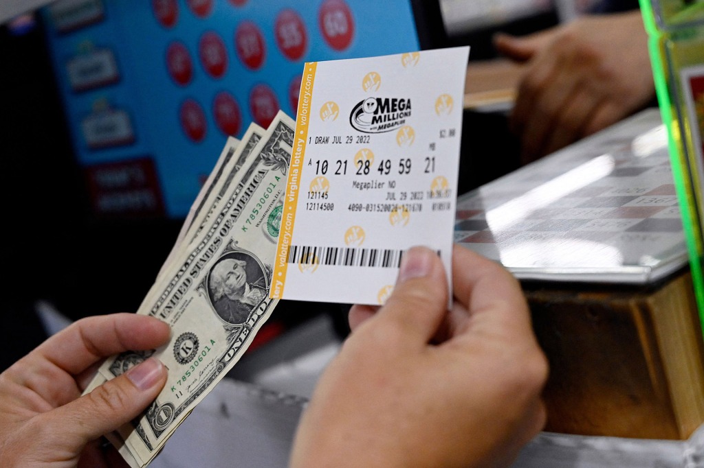 Person holding Mega Millions ticket and cash