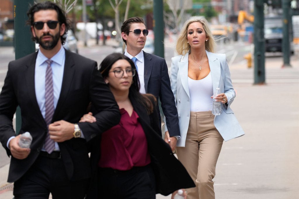 The son, left, and daughter, back right, of Pittsburgh dentist Lawrence "Larry" Rudolph head into federal court for the afternoon session of the trial, July 13, 2022, in Denver.