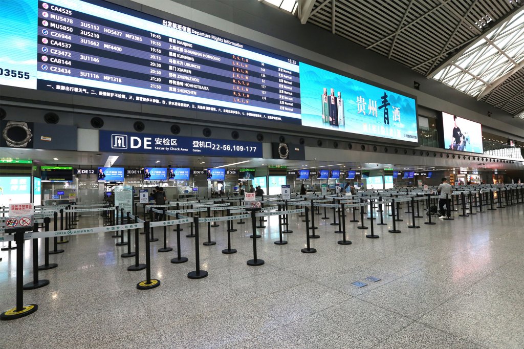 A small number of pedestrians prepare to board a plane at Chengdu Shuangliu Airport amid the Covid-19 lockdown.