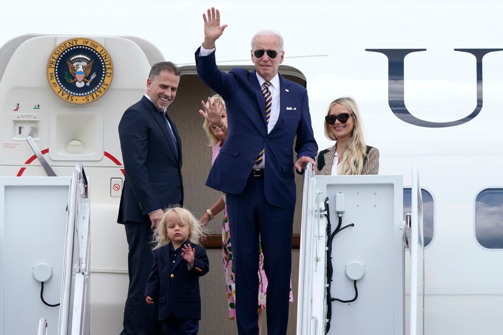 President Joe Biden, center, waves as he is joined by, from left, son Hunter Biden, grandson Beau Biden, first lady Jill Biden, and daughter-in-law Melissa Cohen
