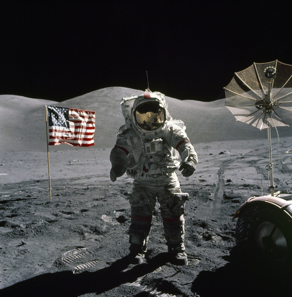 DECEMBER 12:  Apollo 17  commander Eugene A. Cernan stands by the American flag during his second space walk becoming the last man to walk on the Moon on December 12, 1972. 