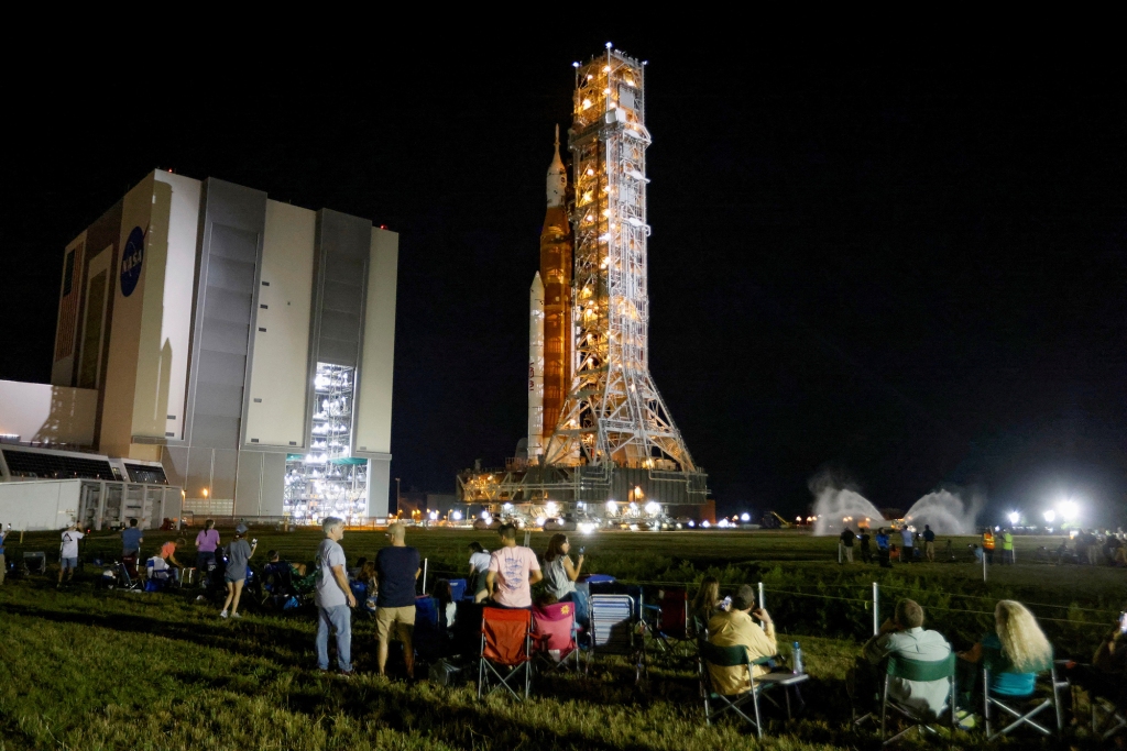 NASA employees and guests look on.