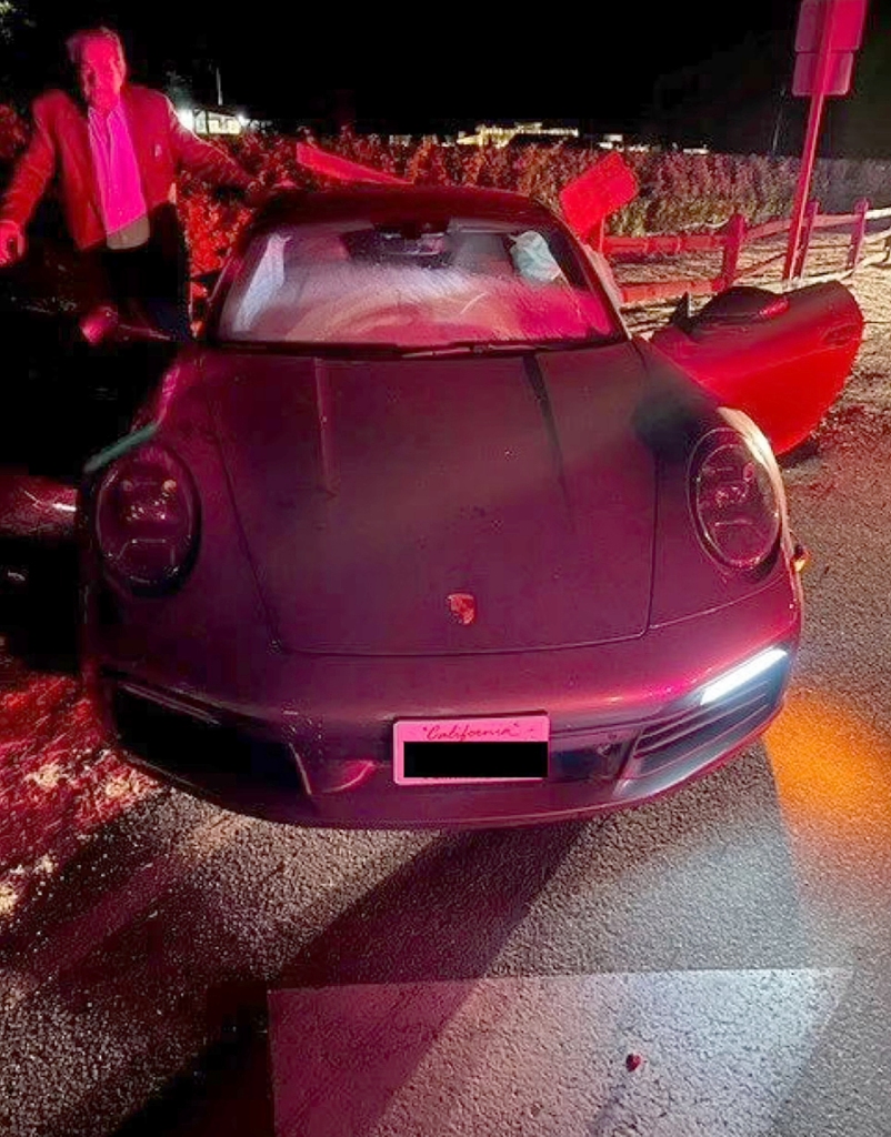 Paul Pelosi stands beside his wrecked Porsche after his crash in May.