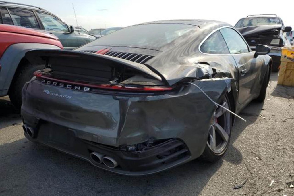 Photo from copart.com showing damage to the rear driver's side of Pelosi's Porsche