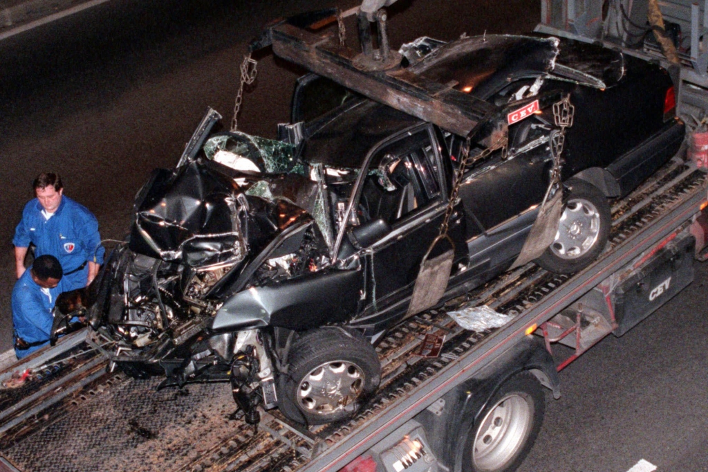 **  FILE  ** Police  take away the car in which Diana, Princess of Wales, died in this Sunday, Aug. 31, 1997 file photo taken in Paris. The car crash  also killed her companion Dodi Fayed and the chauffeur. Princess Diana wrote in a letter months before her death that she feared  someone was planning to kill her in a staged car accident, a London tabloid newspaper reported Monday Oct. 20, 2003.  In excerpts from a forthcoming book by by Diana's one-time butler Paul Burrell, The Daily Mirror quoted the princess as writing that "this particular phase in my life is the most dangerous. "(AP Photo/Jacques Brinon)
