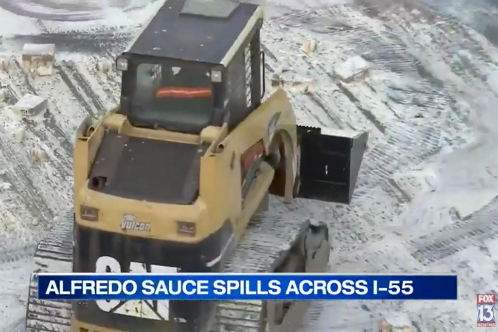 Clean up crews on a tractor trailer help clear the Alfredo sauce that covered the northbound side of the highway.