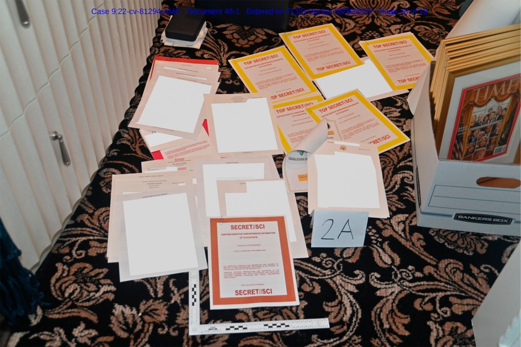 Documents obtained from Trump's Mar-a-Lago home by the FBI are spread across the floor.
