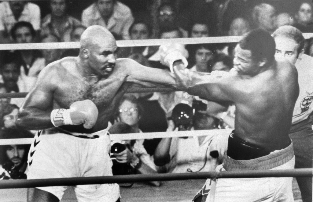 Earnie Shavers (L) throws a left jab against Larry Holmes during their second bout.