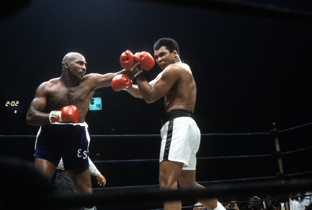 Earnie Shavers (L) throws a punch against Muhammad Ali.