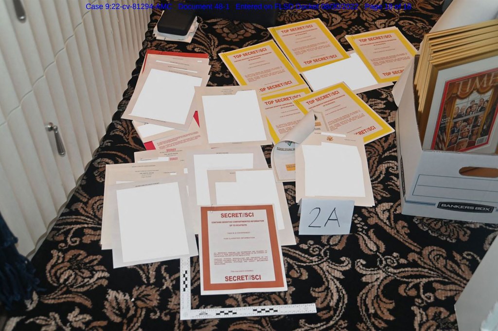 This undated file photo released by the US Department of Justice on August 31, 2022 shows a photo attached as evidence to a court filing by the US District Court Southern District of Florida, of documents allegedly seized at Mar-a-Lago spread over a carpet.