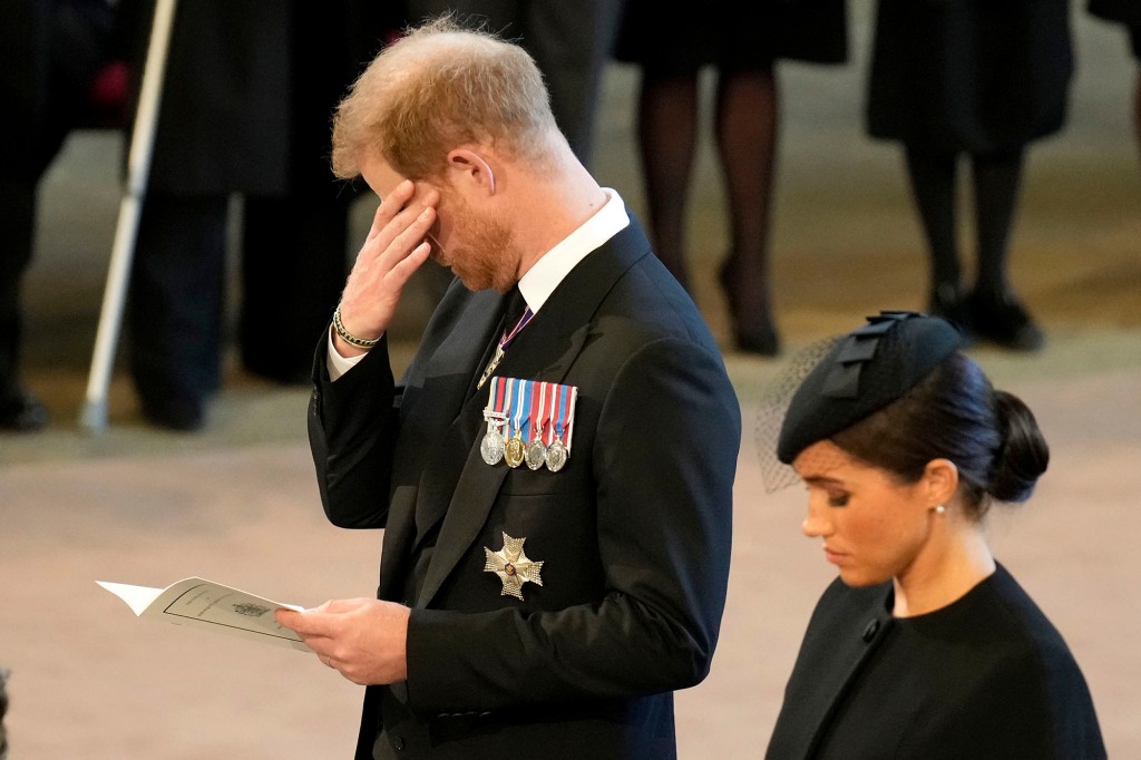 Prince Harry, and his wife Meghan, Duchess of Sussex, pay their respects to Queen Elizabeth
