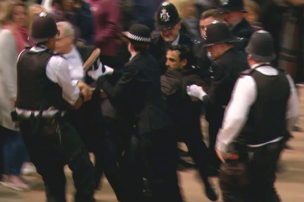 The man who charged the Queen's coffin was charged with criminal disruptions.