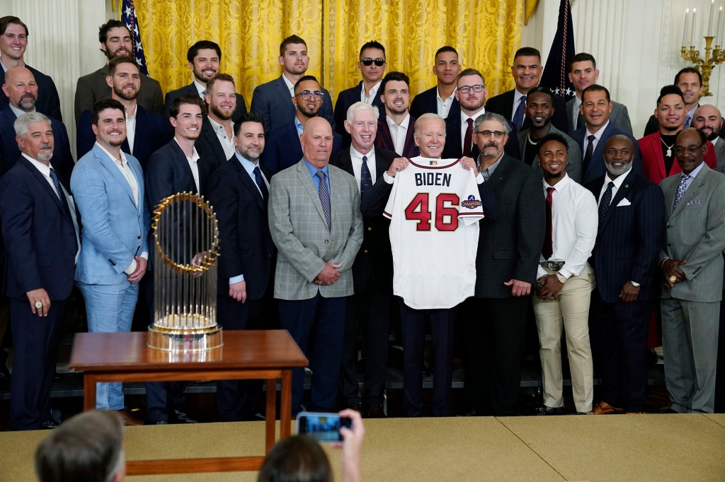 President Joe Biden holds an Atlanta Braves jersey during an event celebrating the Major League Baseball 2021 World Series champion Atlanta Braves in the White House.