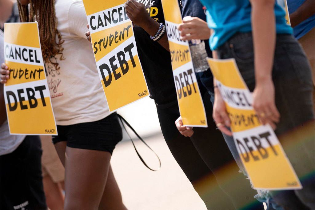 Activists hold signs